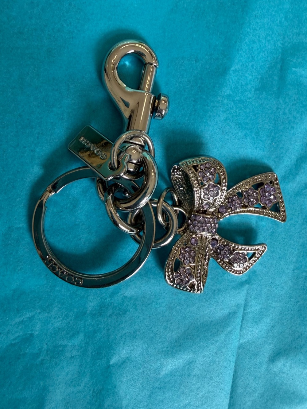 Coach Silver-Tone Keyring with Lavender Crystal Bow Charm